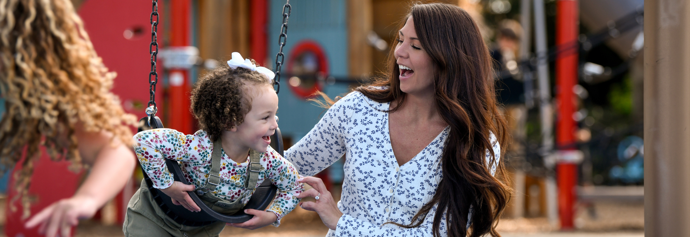 Lifestyle - child on a swing with mother